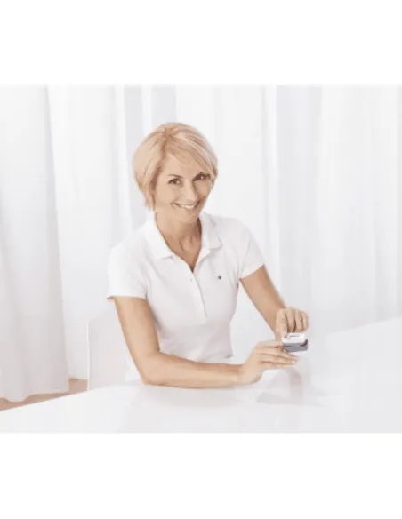 Woman using the Medisana PM100 Pulse Oximeter to measure blood oxygen levels