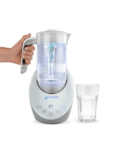 Fastome hydrogen water jug held by a hand next to a glass of water